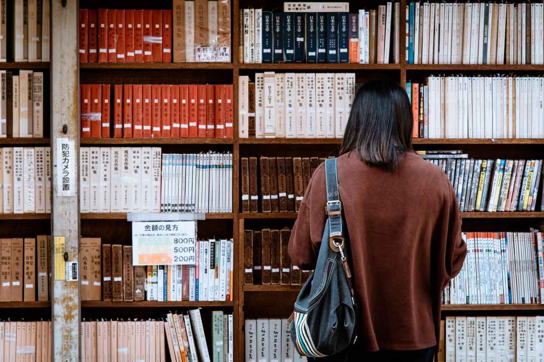 Women looking at books on a shelf