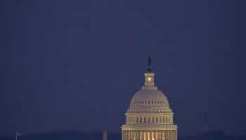 United States capitol under the evening moon.